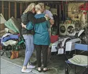  ?? Irfan Khan Los Angeles Times ?? AVA BURNETTE, left, and parents, James and Ann Burnette, pray after the plane fell next to their home.