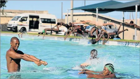  ?? Picture: FREDLIN ADRIAAN ?? IMPARTING A SKILL: Yonwaba Sipeliti teaches more than 100 children swimming and water safety. Among those receiving lessons are Xolani Sihluthe, 14, (obscured by splashing) and Asemahle Mamoti, 14, (in swimming cap)