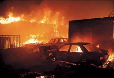  ?? ?? Vehicles and homes burn during a fire in Vina del Mar, Chile, on Friday. — AFP