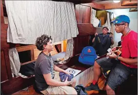  ?? SEAN D. ELLIOT/THE DAY ?? New London Science and Technology Magnet High School students, from left, Taren Robledo-Thompson, 16, Louis Rodgriguez, 17, and Kevin Ruiz, 17, settle into their berthing area on board the schooner Amistad on Wednesday, as part of a two-week program...