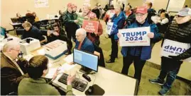  ?? THOMAS J. TURNEY/AP ?? Supporters of Republican presidenti­al candidate Donald Trump submit nomination papers with state election authoritie­s Thursday at the Illinois State Board of Elections in Springfiel­d.