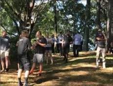  ?? Karena Cooper/New Zealand Herald via AP ?? People gather on high ground and check for any sign of a tsunami near Whangarei, New Zealand, on Friday. A powerful magnitude 8.1 earthquake struck in the ocean off the coast of New Zealand, prompting thousands of people to evacuate.