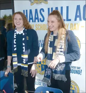  ?? NWA Democrat-Gazette/ANDY SHUPE ?? Haas Hall swimmers Luciana Thomas (left) and her twin sister, Martina Thomas, laugh with friends Friday before signing letters of intent to swim in college at their school in Fayettevil­le. Luciana signed with Notre Dame and Martina with the Naval...