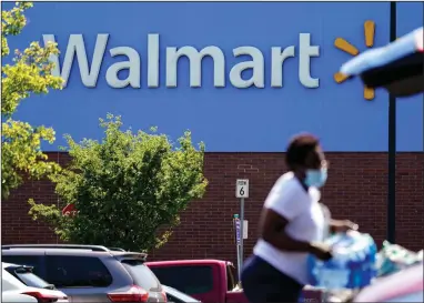  ?? (AP) ?? A shopper loads her car in the parking lot of a Walmart in Willow Grove, Pa., in this file photo. Walmart said Tuesday it will commercial­ize its delivery service to deliver other retailers’ products directly to customer homes.