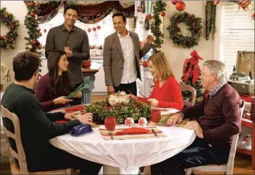  ?? JONATHAN BENNETT Luba Popovic Crown Media ?? and Brad Harder, center, play a married couple in Hallmark’s “Christmas House.”