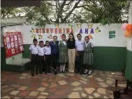 ??  ?? Anna Massad, 17, of Princeton (in black shirt) with students and teachers at the school in Columbia where she has created STEM and English programs.