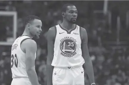  ?? AP Photo ?? FILE. In this Feb. 8, 2019, file photo, Golden State Warriors guard Stephen Curry (30) and forward Kevin Durant (35) pause during the first half of an NBA basketball. Curry knows he and Durant will reminisce with fondness about their three insanely successful years together on the Golden State Warriors.