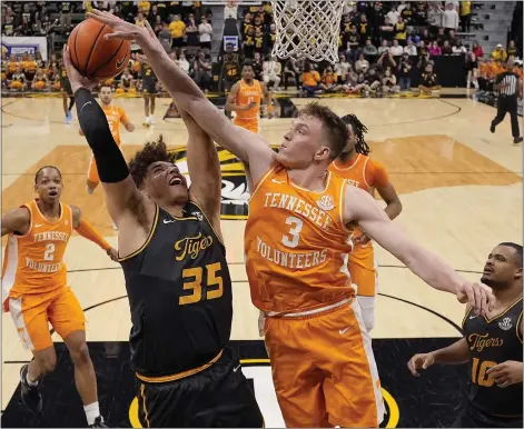  ?? CHARLIE RIEDEL — THE ASSOCIATED PRESS ?? Tennessee guard Dalton Knecht, right, blocks a shot by Missouri forward Noah Carter, center during the second half on Feb. 20in Columbia, Mo.