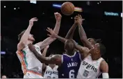  ?? JAE C. HONG – THE ASSOCIATED PRESS ?? The Lakers’ LeBron James, center, is defended by the Spurs’ Jakob Poeltl, left, and Dejounte Murray during the first half.