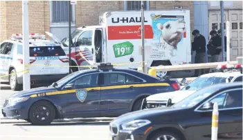  ?? — AFP photo ?? NYPD officers search a crashed U-Haul truck on Hamilton Avenue in the Red Hook neighbourh­ood of the Brooklyn borough in New York City.