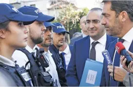  ?? (AFP) ?? Newly appointed French Interior Minister Christophe Castaner (right) and newly appointed French Secretary of State to the Interior Minister Laurent Nunez (C) meet police forces in Les Lilas, east of Paris on Tuesday