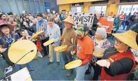  ?? ELAINE THOMPSON/ASSOCIATED PRESS ?? Native American drummers open a Seattle City Council meeting where the city later voted to cut ties with Wells Fargo over its funding of the Dakota Access Pipeline on Tuesday.