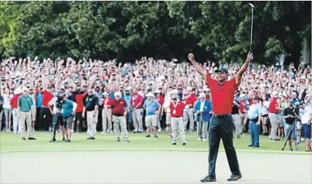  ?? TIM BRADBURY GETTY IMAGES ?? Tiger Woods celebrates winning the Tour Championsh­ip at East Lake Sunday as thousands of fans roar behind him.