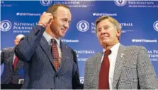  ?? THE ASSOCIATED PRESS ?? Former University of Tennessee football quarterbac­k Peyton Manning, left, and former University of Florida football quarterbac­k and coach Steve Spurrier get together after a news conference of the National Football Foundation and College Football Hall of Fame on Tuesday in New York.