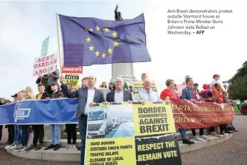  ?? — AFP ?? Anti-brexit demonstrat­ors protest outside Stormont house as Britain’s Prime Minister Boris Johnson visits Belfast on Wednesday.