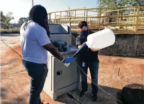  ?? Courtesy of the city of Houston ?? City of Houston public works employees handle wastewater samples at various lift stations and manholes in the city. The wastewater is analyzed to detect SARS-CoV-2.