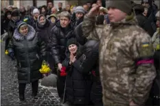  ?? EMILIO MORENATTI — THE ASSOCIATED PRESS ?? Anastasia, center, cries as soldiers carry the coffin of her brother Oleg Kunynets, a Ukrainian military serviceman who was killed in the east of the country, during his funeral in Lviv, Ukraine, on Tuesday.