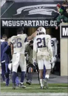  ?? CARLOS OSORIO — THE ASSOCIATED PRESS ?? Penn State running back Saquon Barkley (26) and cornerback Amani Oruwariye (21) walk out of Spartan Stadium after Saturday’s loss in East Lansing, Mich.