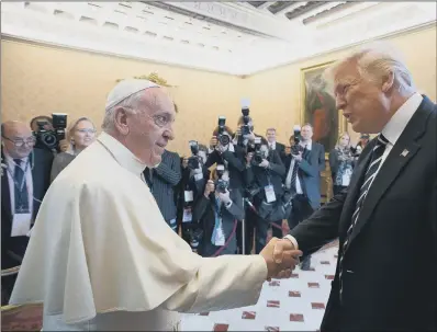  ??  ?? Pope Francis shakes hands with President Donald Trump on the occasion of their private audience, at the Vatican.