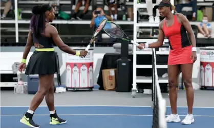  ?? Photograph: Dylan Buell/Getty Images ?? Serena Williams and Venus Williams touch rackets after Serena’s 3-6, 6-3, 6-4 win at the Top Seed Open.