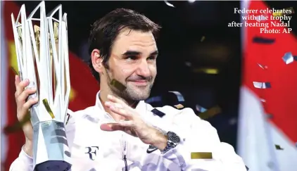  ?? Photo: AP ?? Federer celebrates with the trophy after beating Nadal