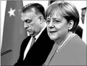  ?? OMER MESSINGER/GETTY-AFP ?? German’s Angela Merkel and Hungary’s Viktor Orban attend a news conference Thursday after a meeting in Berlin.