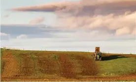  ?? Photograph: Chris Strickland/Alamy Stock Photo ?? A farmer spreads manure over a field in the Scottish Borders. Cutting emissions from agricultur­e – including ammonia from manure and fertiliser­s, has proved a challenge.