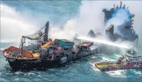  ??  ?? Smoke billows from the Singapore-registered container ship MV X-press Pearl, which has been burning for 11 straight days, as firefighti­ng vessels on Sunday try to douse the fire in the waters off the harbour in Colombo. Sri Lankan authoritie­s want to sue the owners of the cargo carrier as a portion of the 25 tonnes of nitric acid it was carrying has fallen into the sea and caused marine pollution around the island nation’s west coast.