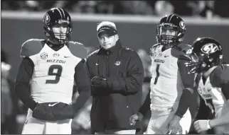  ?? The Associated Press ?? Missouri football coach Gary Pinkel, center, has guided his Tigers to an unlikely appearance in
                                                                                                                                                           ...