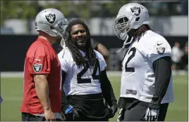  ?? Eric Risberg ?? The Associated Press Raiders tackle Donald Penn, right, with running back Marshawn Lynch, center, and kicker Sebastian Janikowski at the team’s spring session in Alameda, Calif.