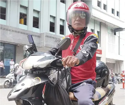  ?? ?? 58-year-old Placido Parallag Jr. is a former habal-habal rider who now plies the busy thoroughfa­res of Metro Manila as a profession­al moto-taxi serviceman – even becoming one of MOVE IT’s top riders in 2023