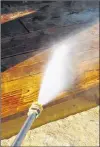  ?? STEVE MAXWELL PHOTO ?? A pressure washer is the best tool to use for removing an old deck finish that’s been softened by a watersolub­le deck stripper.