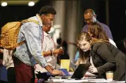  ?? LM OTERO / ASSOCIATED PRESS ?? Job seeker Dalvin Jones (left) chats with Valmira Haxhimusa during a recent Dallas jobs fair. The jobless rate in April fell to a decade low of 4.4 percent, below the level the Fed considers as full employment.