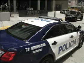  ?? AP PHOTO/ARNULFO FRANCO ?? In this Feb. 27, file photo, a Panamanian police car passes in front the Trump Ocean Club Internatio­nal Hotel and Tower in Panama City. The hotel remains open for business against a backdrop of service interrupti­ons, bad press and a fight over Trump’s management contract that ended in fisticuffs and repeated police calls last week.