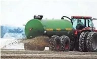  ?? WISCONSIN STATE FARMER ?? A farmer applies manure to his fields.