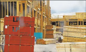  ?? Rachel Aston Las Vegas Review-Journal @rookie__rae ?? Stacks of wood in March at the new Rose Gardens public housing complex in North Las Vegas. The Trump administra­tion’s tariffs on Canadian lumber imports as well as tariffs on steel and aluminum imports have some worried about the possible impacts on the valley’s housing market.