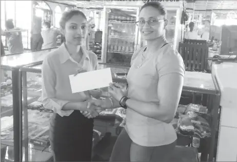  ??  ?? Marketing Manager of the Gym, Christine Dharry (left) yesterday presented a sponsorshi­p pact to GAPF Committee Member and Master’s One National gold medalist Nadina Taharally to help offset expenses of the competitio­n.