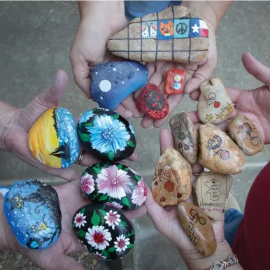  ?? Staff photo by Evan Lewis ?? n Rochelle Walk, Stephanie Schutte and Stephanie Pond show some of the rocks they have either painted or collected.