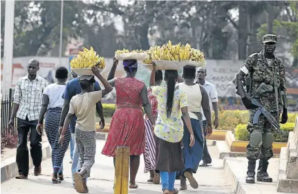  ?? / JAMES AKENA/REUTERS ?? People go about their daily business in the streets of Kampala. Ugandan police have been accused of ignoring crime in favour of crushing political dissent.