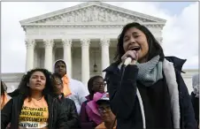  ?? ASSOCIATED PRESS ?? Michelle Lainez, 17, originally from El Salvador but now living in Gaithersbu­rg, Md., speaks during a rally outside the Supreme Court in Washington Friday. Republican control of the White House, Senate and conservati­ve justices on the Supreme Court will negate gains made locally by Democrats.