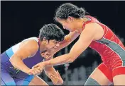  ??  ?? Sonam Malik (left) fights against Mongolia's Battsetseg Soronzonbo­ld in the women's 62kg freestyle on Tuesday.