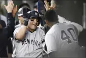  ?? NICK WASS — THE ASSOCIATED PRESS ?? New York Yankees’ Jose Trevino, left, celebrates his three-run home run with teammate Luis Severino (40) and others in the dugout during the fourth inning against the Baltimore Orioles on Monday.