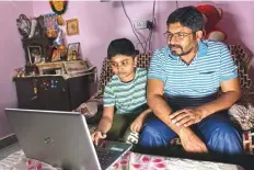  ?? New York Times ?? Anil Kumar with his 10-year-old son, Akshay, at home in the Palam neighbourh­ood in Delhi, India.