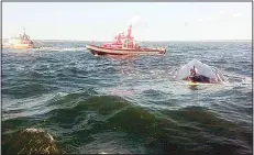  ??  ?? In this July 26, photo provided by the US Coast Guard, boats float beside a capsized vessel off the coast of Wareham, Mass. Authoritie­s said 12 people, most of them children, were rescued and hospitaliz­ed after the boat overturned
Wednesday. (AP)