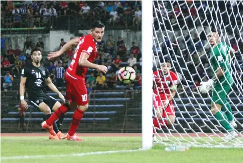  ??  ?? GOAL: Sabah captain Rawilson Batuil (second right) heads past JDT II goalkeeper Samuel Jacob Somerville as striker Rodoljub Paunovic (second left) looks on as the ball bounces into the empty net.