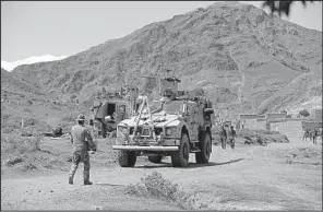  ?? AP/RAHMAT GUL ?? U.S. forces and Afghan commandos work Saturday in Asad Khil village, near the site in Afghanista­n’s Nangarhar province where a U.S. bomb struck an Islamic State tunnel complex last week.