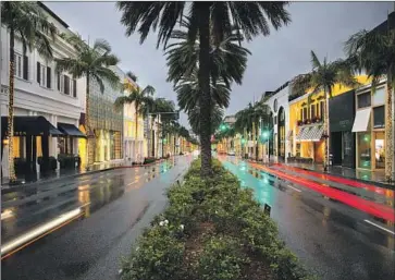  ?? Jay L. Clendenin Los Angeles Times ?? RODEO DRIVE, in the heart of Beverly Hills, is empty on a recent evening. House passage of the $2-trillion stimulus plan is expected to help lift consumer sentiments and spending, as well as the broader economy.