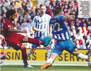  ?? REUTERSPIX ?? Liverpool’s Mohamed Salah scores their first goal against Brighton yesterday. –