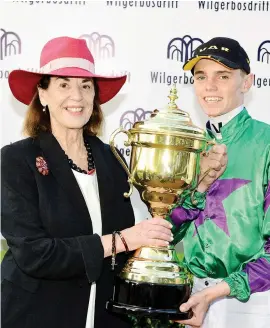  ?? Greg Mulford Picture: ?? HAPPY DAY: Callan Murray receives the trophy from Mary Slack following the victory of Takingthep­eace in the Grade 1 Wilgerbosd­rift SA Fillies Classic, the second leg of the R1-million Wilgerbosd­rift Triple Tiara.