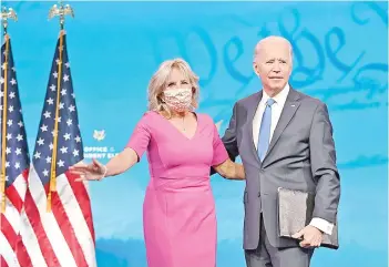  ?? — AFP photo ?? Biden arrives with wife Jill to deliver remarks on the Electoral college certificat­ion at the Queen Theatre in Wilmington, Delaware.